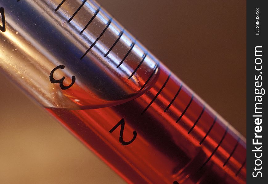 Pen-syringe with red liquid inside closeup
