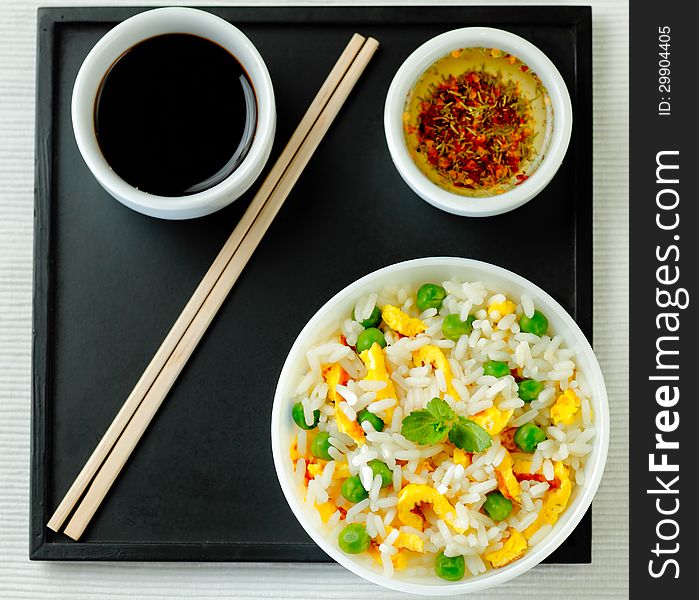 Bowl of fried rice, peas and egg with oyster sauce and aromatic oil