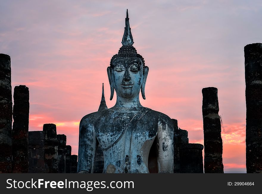 Detail of sitting Buddha at sunset in Sukhothai, Thailand