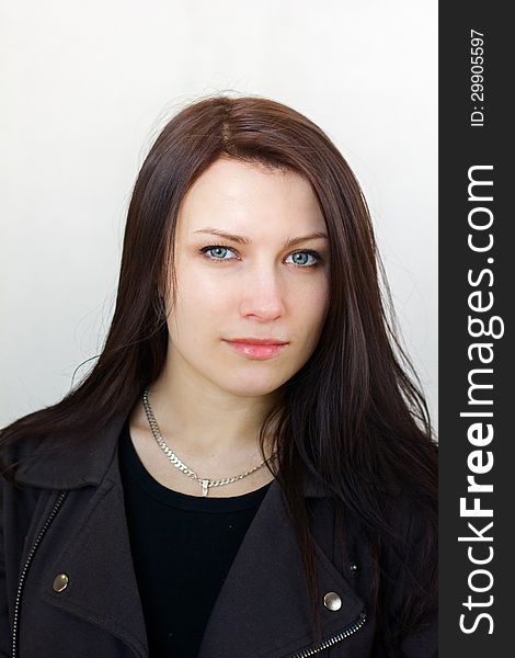 Portrait Of A Beautiful Serious Brunette Girl With Long Hair