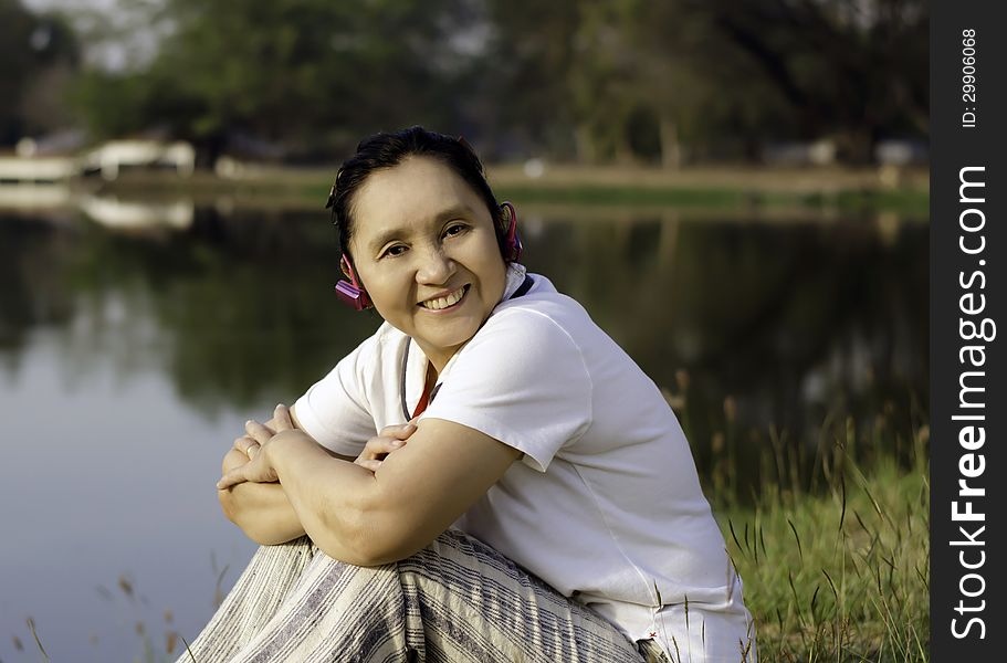 Happy woman listening to music outdoors