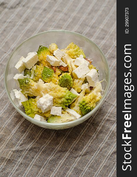 Romanesco, apricot pits and cheese warm salad. Romanesco, apricot pits and cheese warm salad