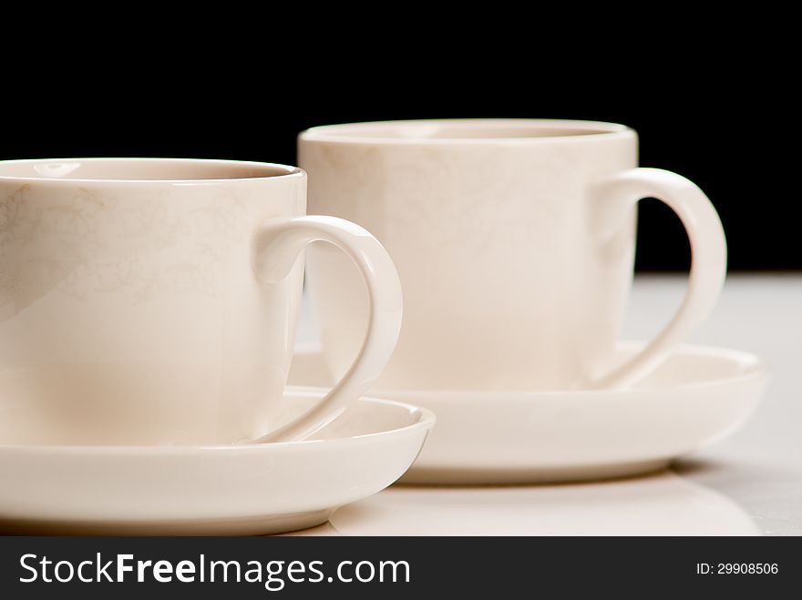 Two cups of tea on black background. Studio shot. Two cups of tea on black background. Studio shot