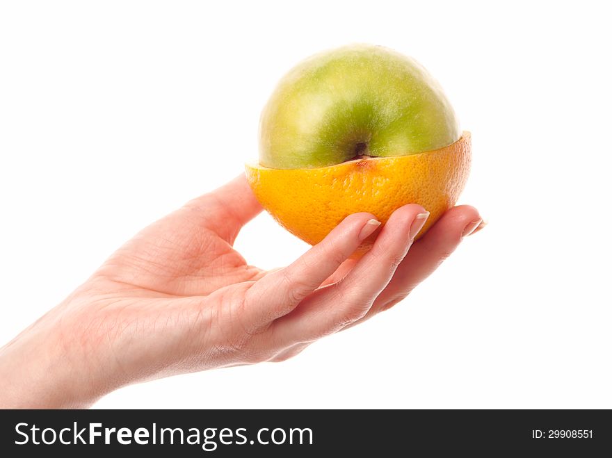 Female hand holdin half of an apple and half of a grapefruit. White background. Studio shot. Female hand holdin half of an apple and half of a grapefruit. White background. Studio shot