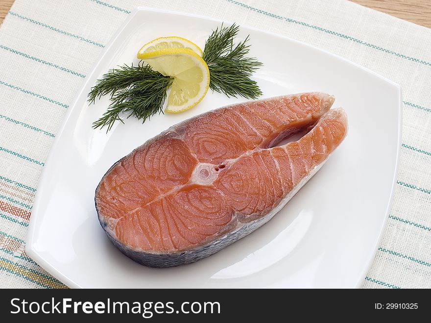 Raw fish steak with lemon and dill