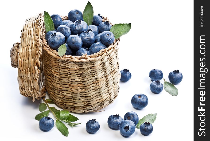 Blueberries in a basket on a white background.