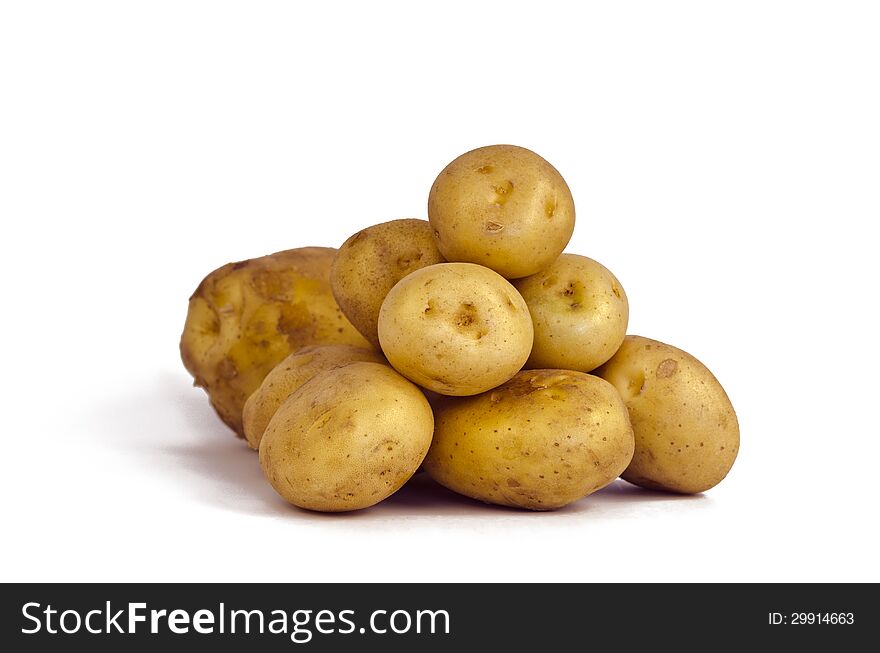 Heap of potatoes isolated on white.