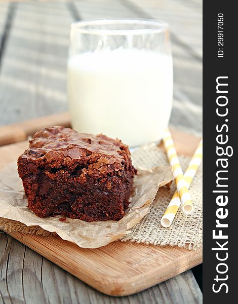 Thick chocolate brownies with a glass of milk. Thick chocolate brownies with a glass of milk.