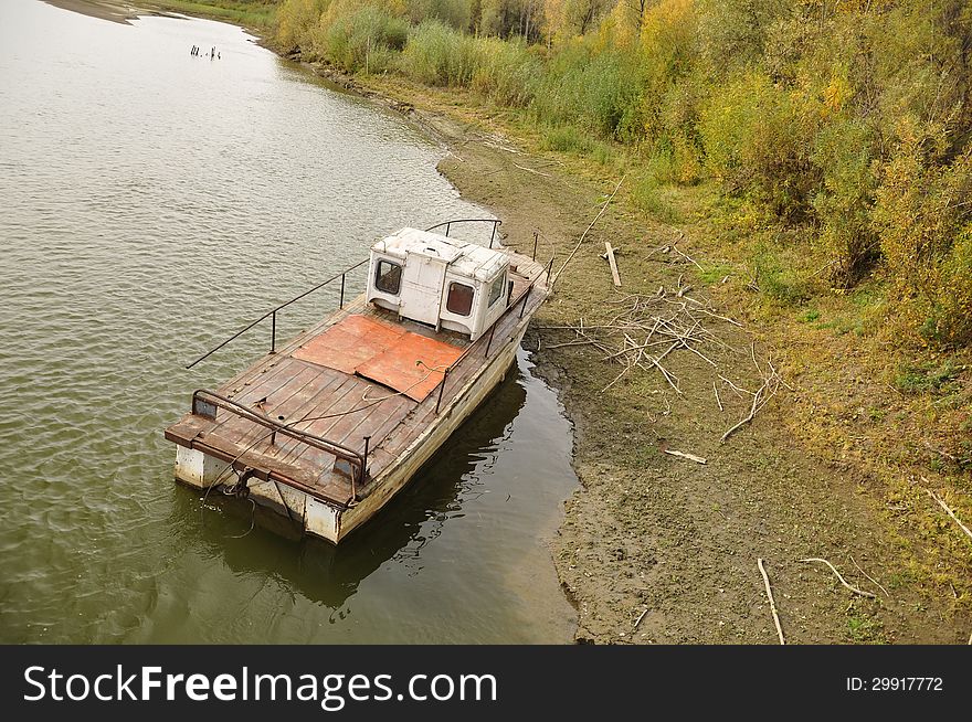 Old boat on the water near the shore. Old boat on the water near the shore.