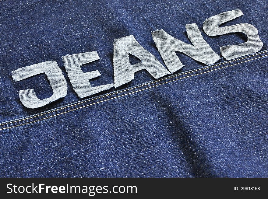 The words jeans on the jeans background. The words jeans on the jeans background.