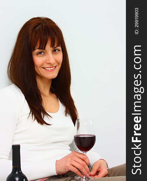 Smiling woman relaxing with glass of red wine isolated. Smiling woman relaxing with glass of red wine isolated