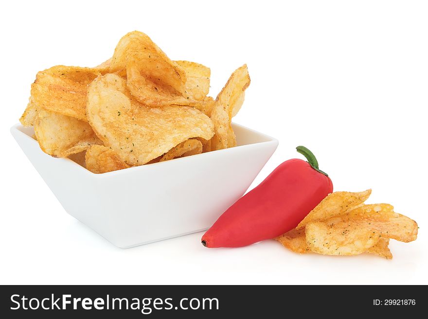 Chili potato crisp snacks in a porcelain dish with red pepper over white background. Chili potato crisp snacks in a porcelain dish with red pepper over white background.