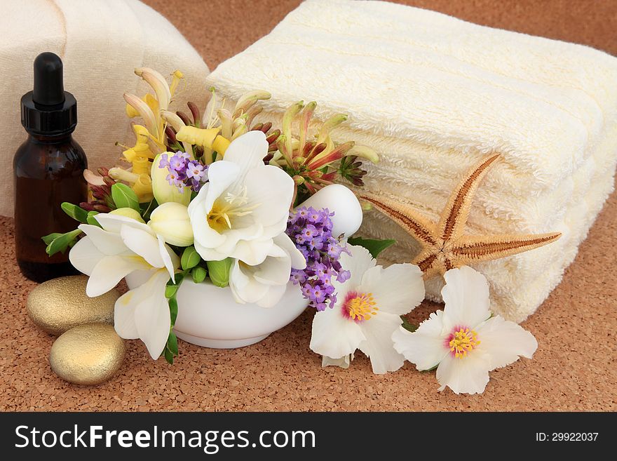 Aromatherapy and spa accessories with freesia, syringa rose, honeysuckle and lavender flowers. Aromatherapy and spa accessories with freesia, syringa rose, honeysuckle and lavender flowers.