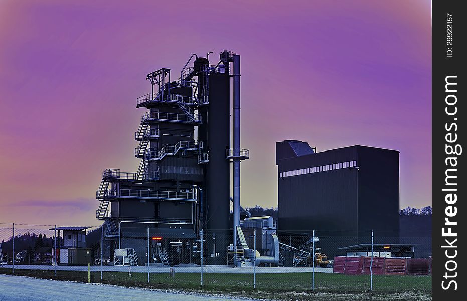 A factory in the blue hour just after sunset with the colorful sky. A factory in the blue hour just after sunset with the colorful sky.