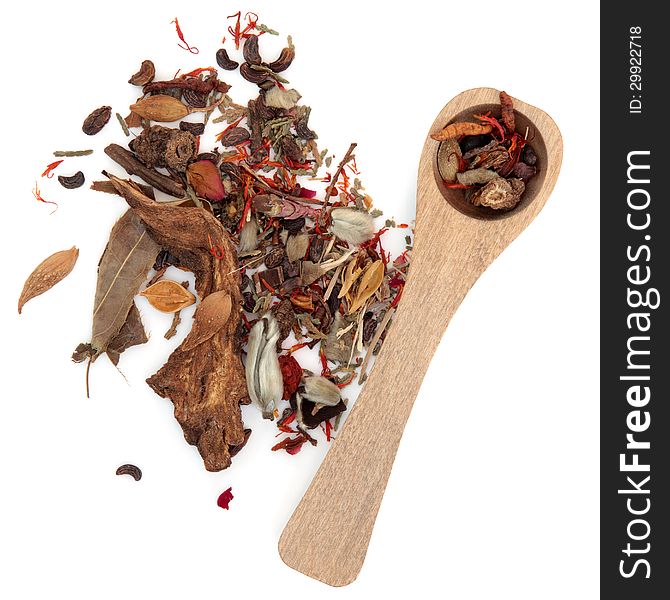 Chinese herbal medicine mixture with wooden spoon over white backgorund.