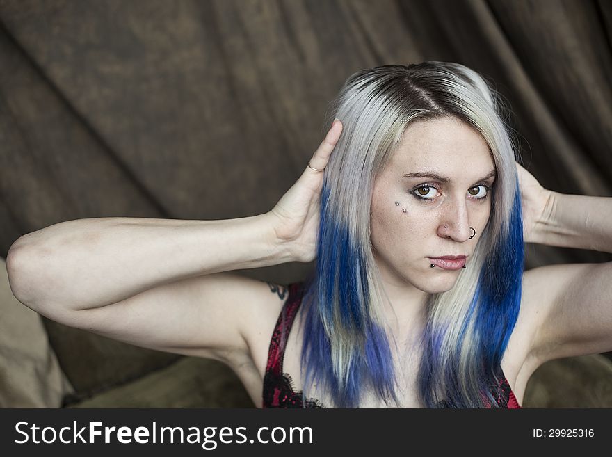 Portrait of a beautiful young woman with blue hair.