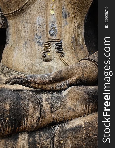 Detail of hand of stone sitting Buddha in Sukhothai historical park, Thailand