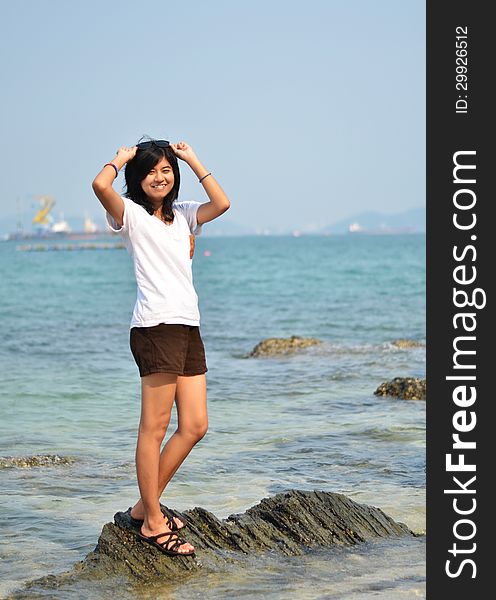 Beautiful Asian girl smiling at the beach