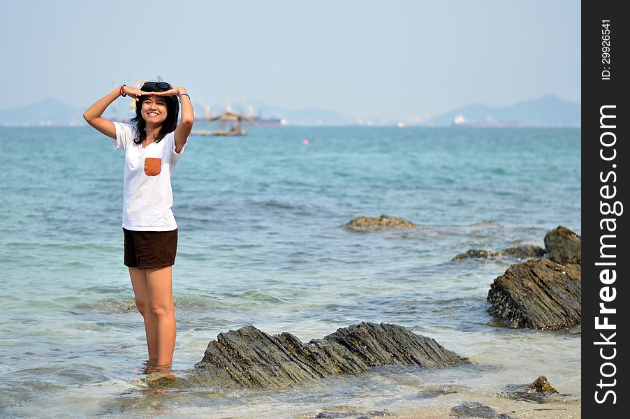Beautiful young woman on beach summer holiday. Portrait of asian