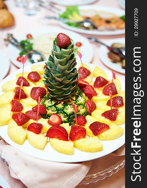 Dish with pineapple at the festive table