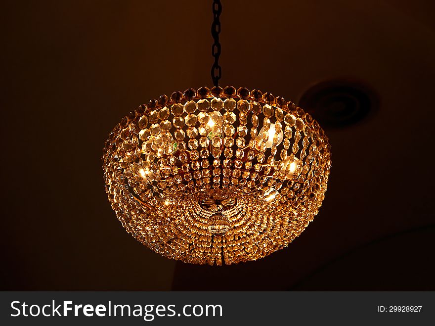 Ancient glass chandelier isolated over black background. Ancient glass chandelier isolated over black background