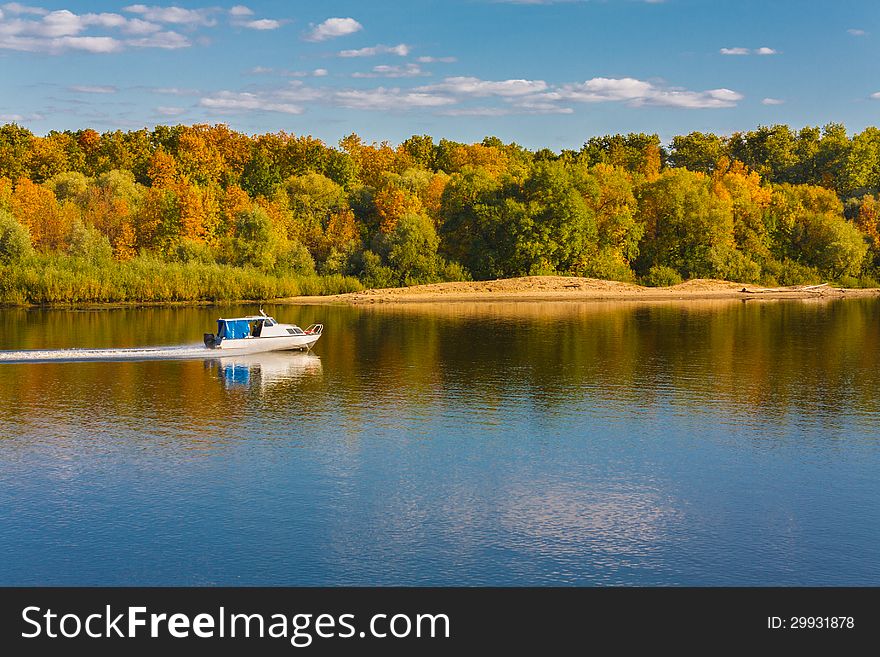 Ship On River. Autumn forest background