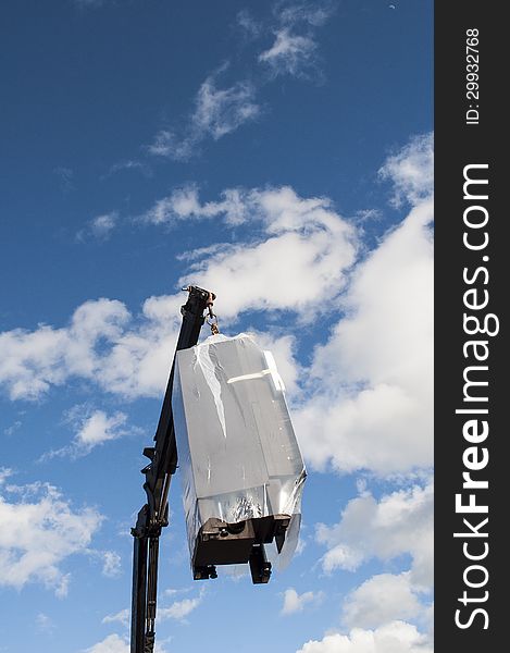 Hydraulic Cranes with fireplace on the background of blue sky