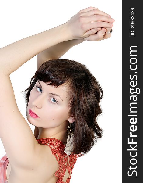 Portrait of a young brunette attractive girl with the hands raised up in in a sexual dress isolated over white background. Portrait of a young brunette attractive girl with the hands raised up in in a sexual dress isolated over white background