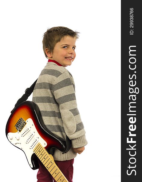 Boy with guitar on his back looking over shoulder. Boy with guitar on his back looking over shoulder.