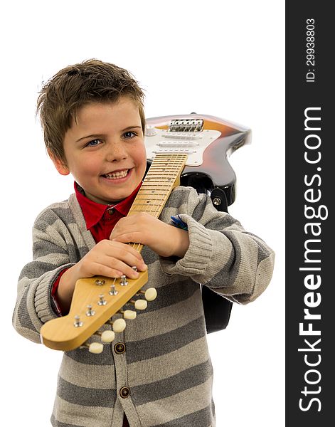 Boy holding a guitar over his shoulder. Boy holding a guitar over his shoulder