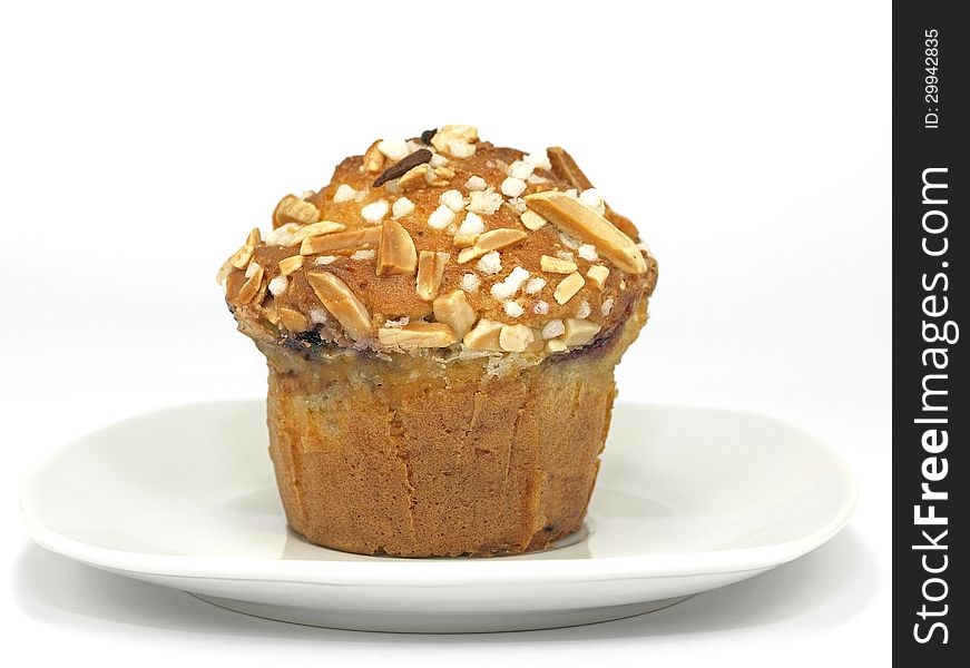 Blueberry muffin with almond toppings on plate