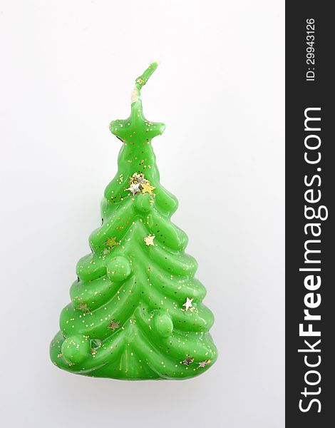 Candle in the form of a Christmas tree on a white background. Candle in the form of a Christmas tree on a white background