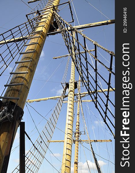 Wooden mast ship on a background of blue sky. Wooden mast ship on a background of blue sky.