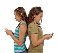 Teenage Girls Text Messaging Instead Of Talking Stock Photography Teenage Girls Text Messaging Instead Of Talking Stock Photography