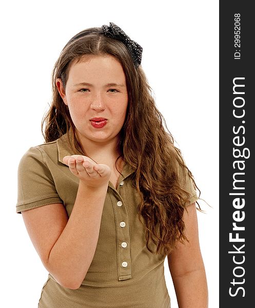 Vertical shot of a young teenage girl blowing kisses to the camera. White background. Vertical shot of a young teenage girl blowing kisses to the camera. White background.
