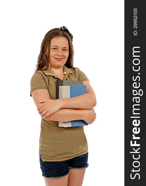 Vertical shot of a young teenage girl holding books and smiling while posing on a white background. Shot in studio. Vertical shot of a young teenage girl holding books and smiling while posing on a white background. Shot in studio.