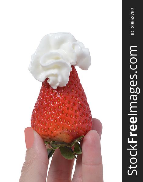 Fingers holding a strawberry with whipped cream. Fingers holding a strawberry with whipped cream