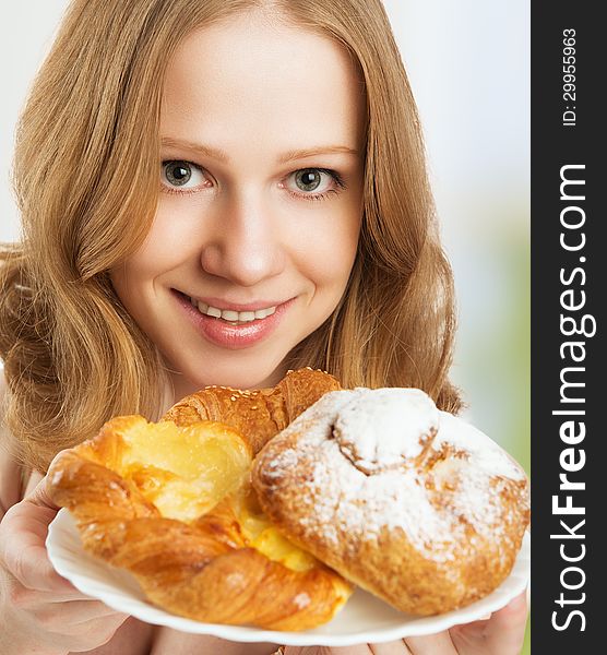 Happy young woman offers treats cakes, scones, muffins, biscuits