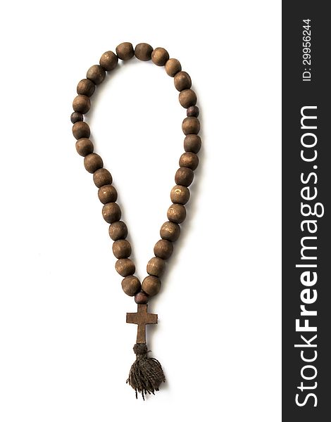Old wooden rosary beads on white background