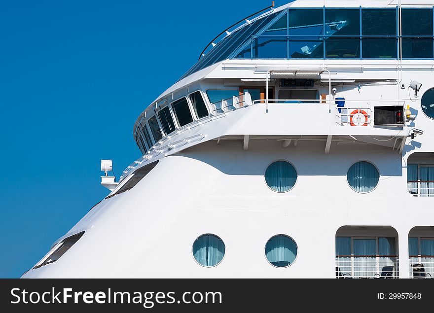 View from the upper deck of a cruise ship. Captain's bridge on the luxury ocean liner. Seaside of the white passenger ship with portholes.