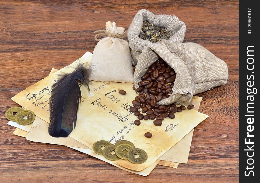 Old vintage letter with feather and coffee in burlap sacks. Old vintage letter with feather and coffee in burlap sacks