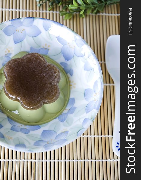 Matcha green tea pudding on plate with spoon. Matcha green tea pudding on plate with spoon