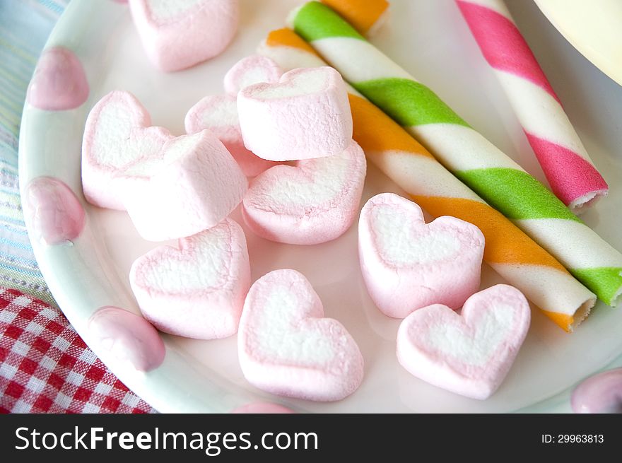 Pink heart marshmallow in colorful candy party. Pink heart marshmallow in colorful candy party