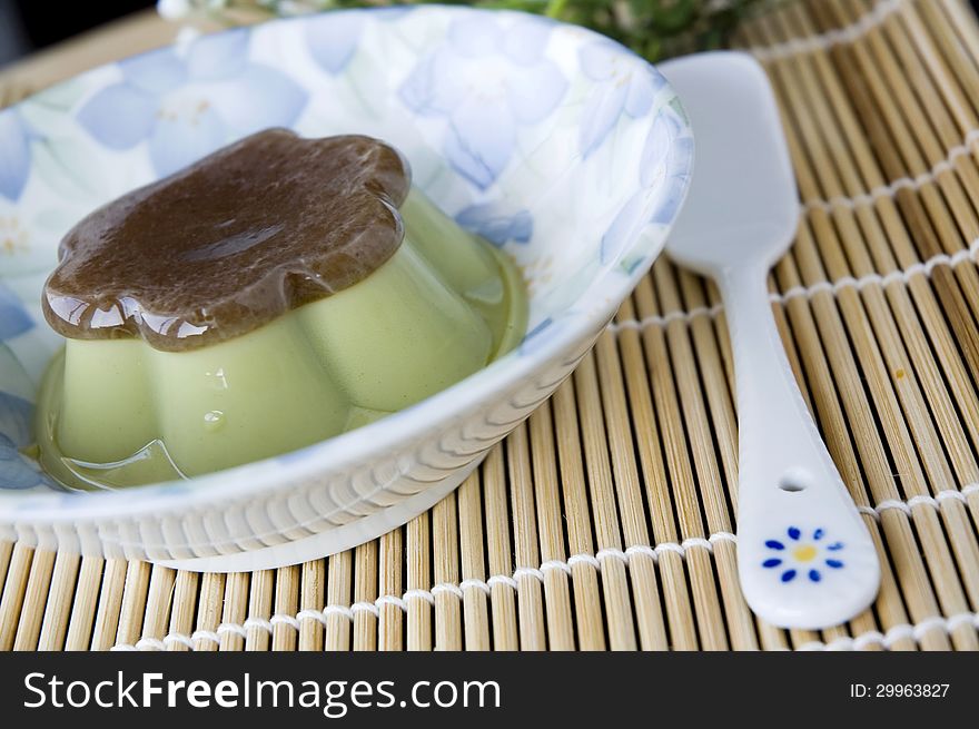 Pudding green tea dessert serve on plate with spoon