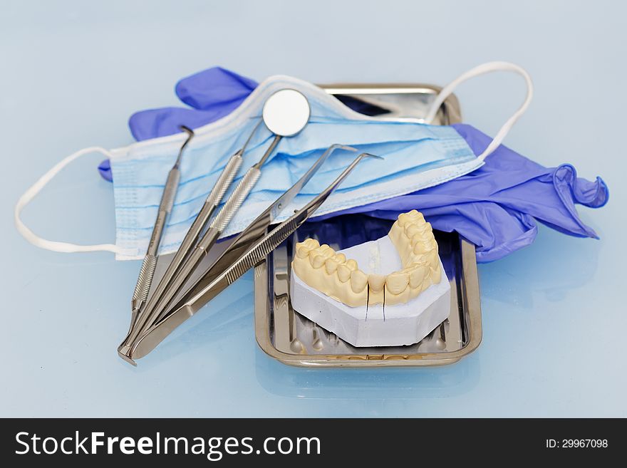 Dental instruments with gloves and mask and model