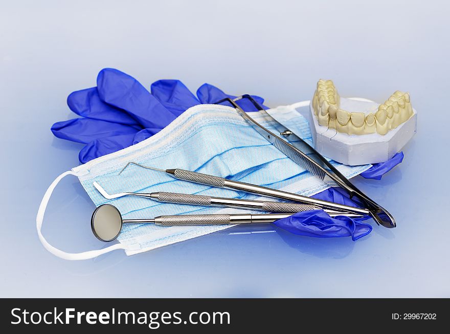 Dental instruments with gloves and mask and model