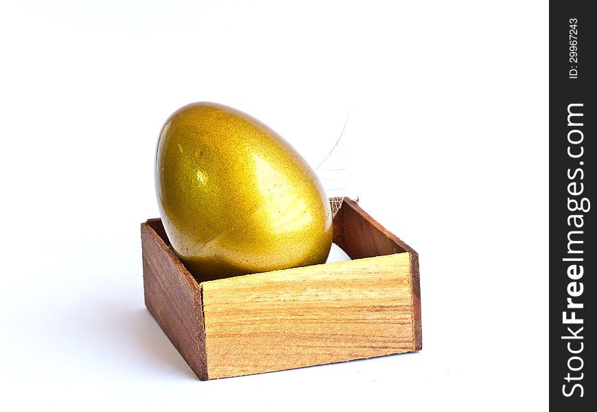 The golden Easter egg in the wooden box