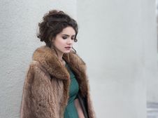 Elegance. Charming Autumn Brunette In Fur Coat In Her Thoughts Stock Photo Elegance. Charming Autumn Brunette In Fur Coat In Her Thoughts Stock Photo