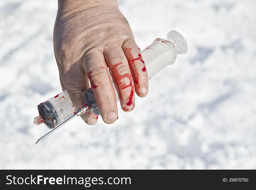 Bloody Hand Holding Syringes