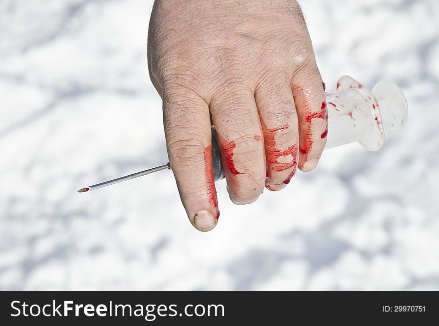 Bloody Hand Holding Syringes